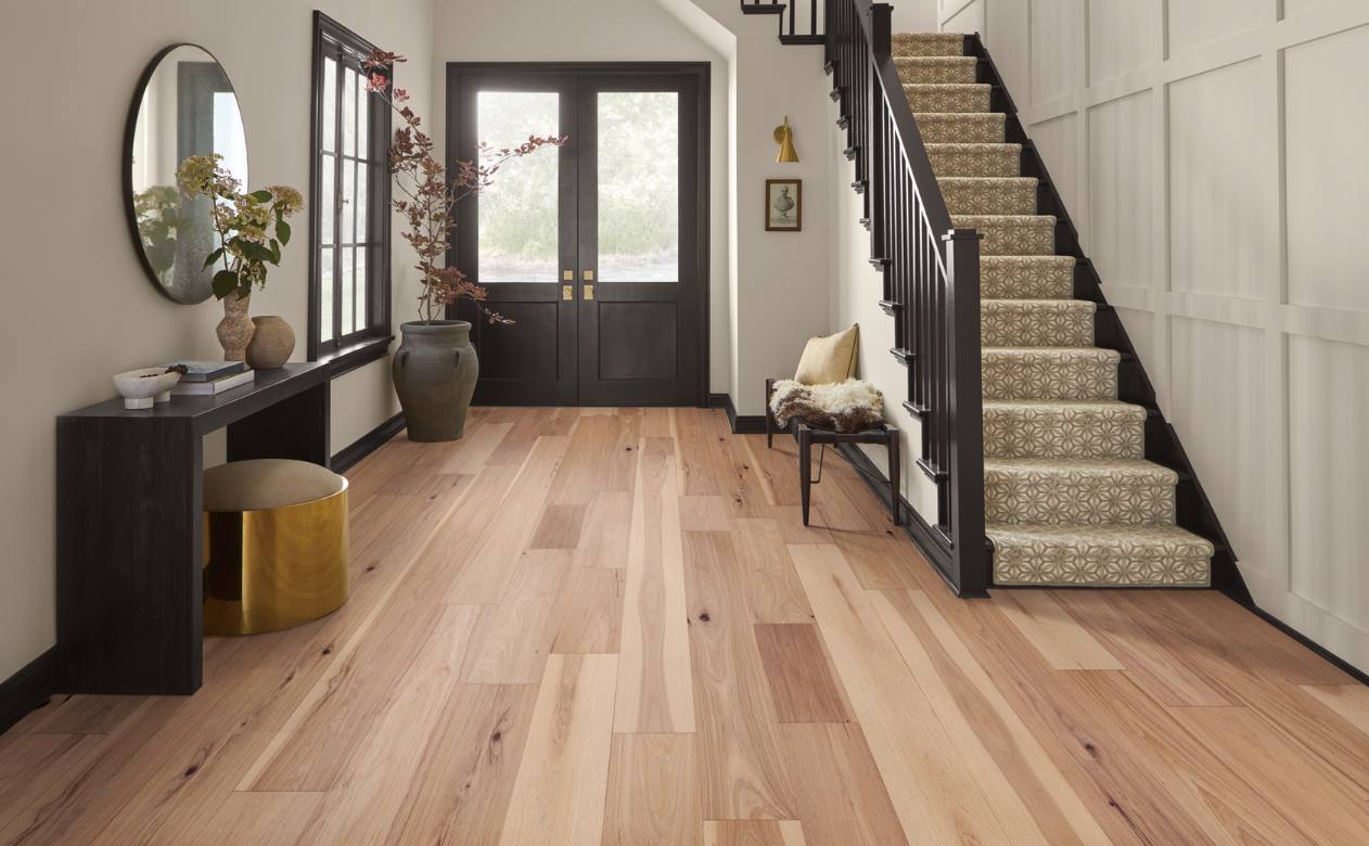 warm toned hardwood flooring in dining room with wood and glass table and wood chairs.