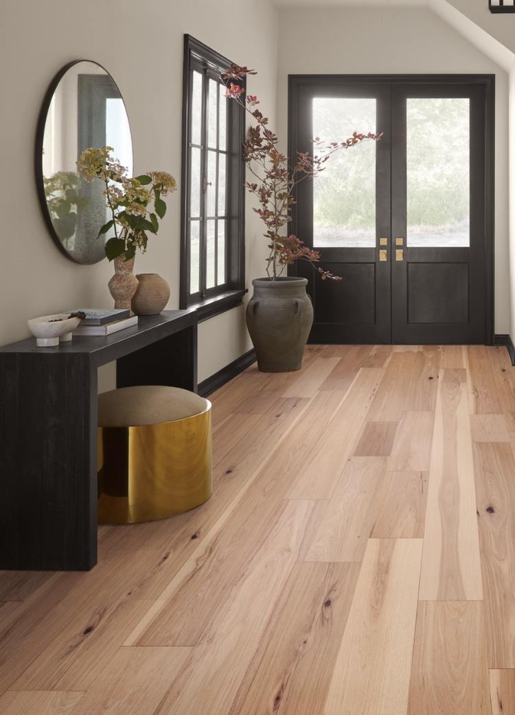 warm toned hardwood flooring in dining room with wood and glass table and wood chairs.